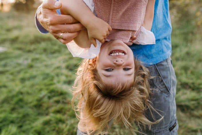 Little girl is upside down. Family photographer in Basingstoke, Hampshire. Ewa Jones Photography