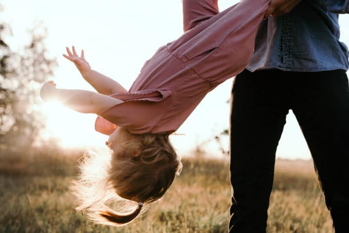 Dad is throwing his little girl in the air. family lifestyle photography in Basongstoke, Hampshire. Ewa Jones Photography