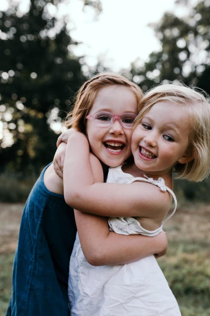 Sisters hugging and laughing. Family photoshoot in Hampshire | Ewa Jones Photography