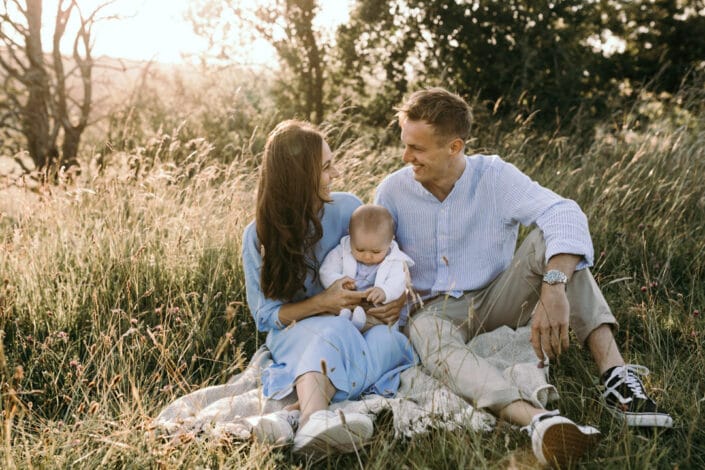 Mum and dad are smiling and looking at each other. Lovely golden hour photo session in the Salisbury hills. Ewa Jones Photography