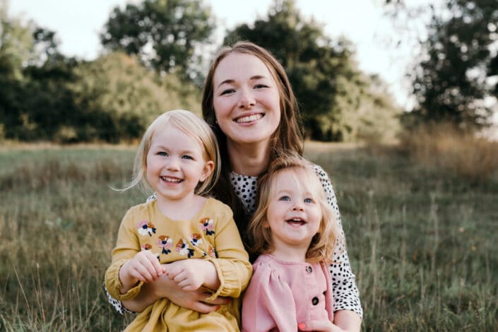 Mum and daughters sitting on the grass | Family lifestyle photography in Basingstoke | Hampshire | Ewa Jones Photography