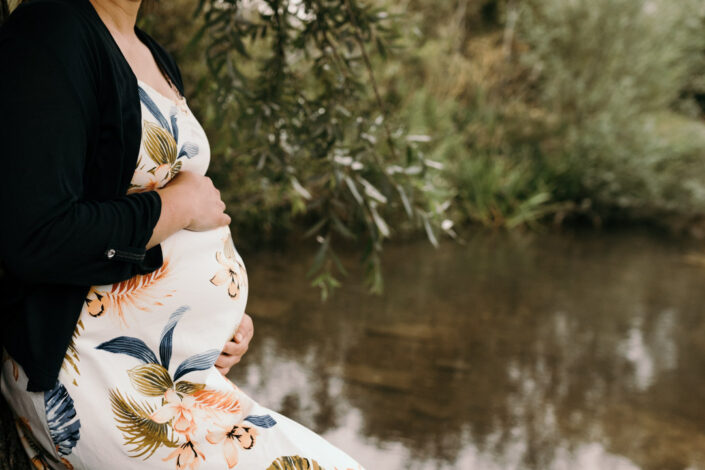 Mum is standing and holding her bump. Maternity photo session in Basingstoke. Ewa Jones Photography