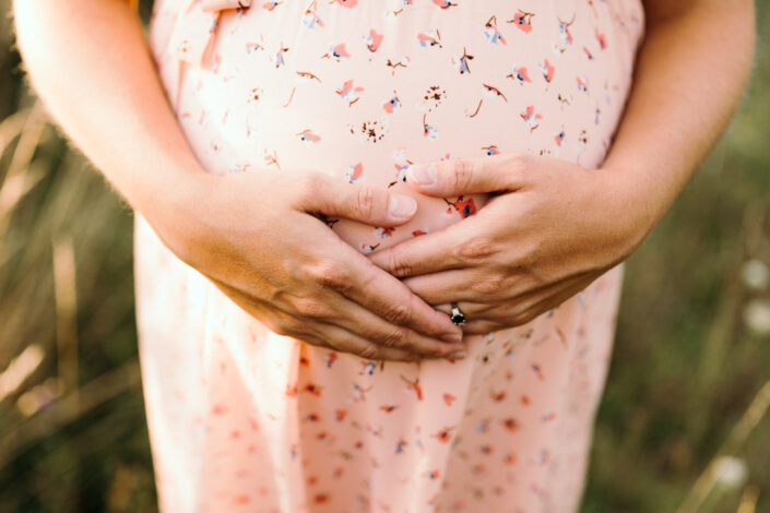 Expecting mum is holding bump. Maternity photo session in Basingstoke. Ewa Jones Photography