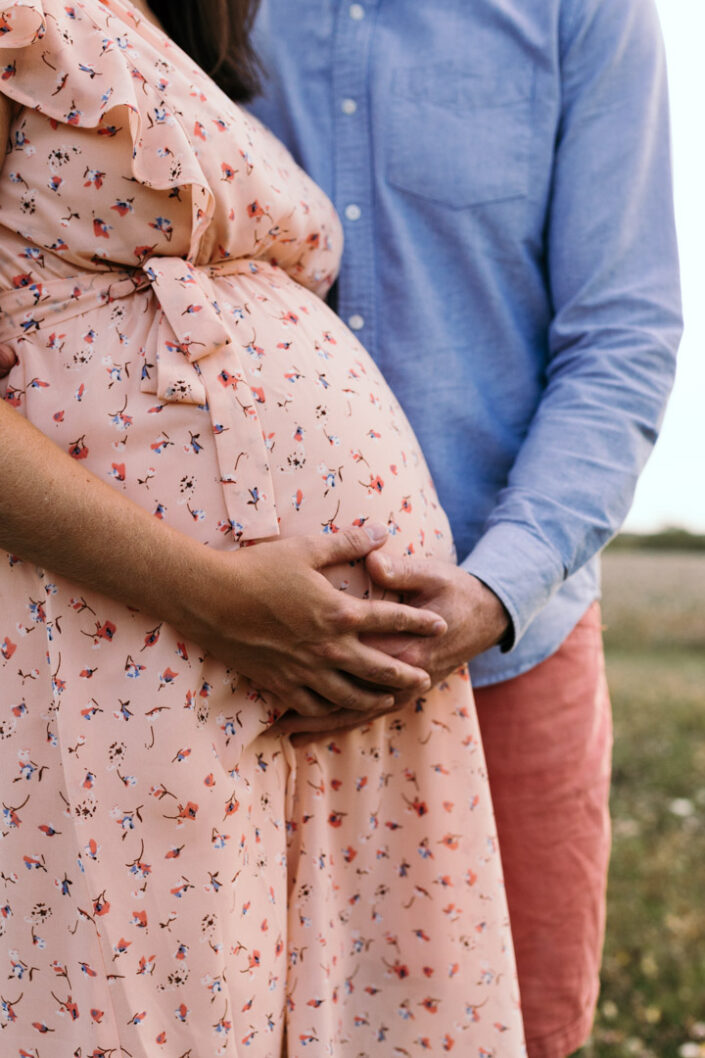 Mum and dad are holding bump. Maternity photographer in Hampshire. Ewa Jones Photography