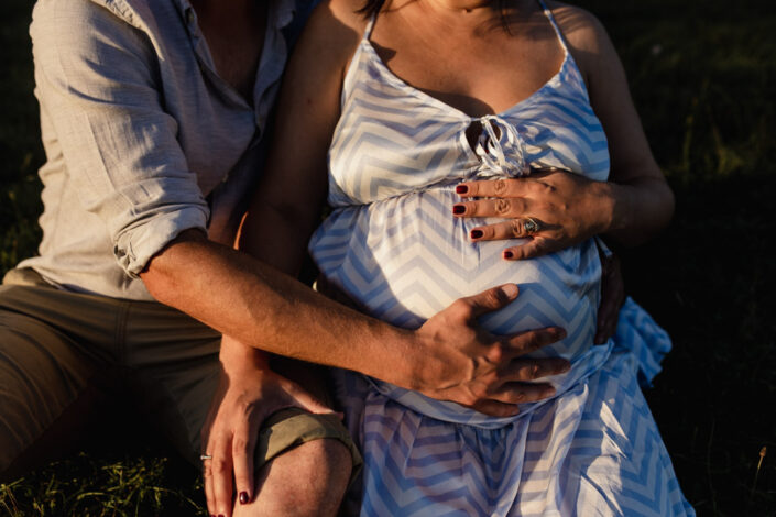 Mum and dad are both holding bump. Maternity photography in Hampshire. Ewa Jones Photography