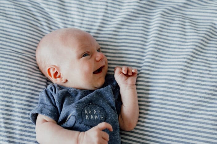 In home lifestyle newborn photo session. Newborn baby on bed. Hampshire newborn baby photographer in Basingstoke. Ewa Jones Photography