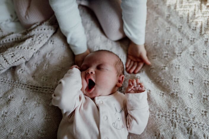 Newborn yawning and laying on the bed. Close up details. Newborn photoshoot in Hampshire. Ewa Jones Photography