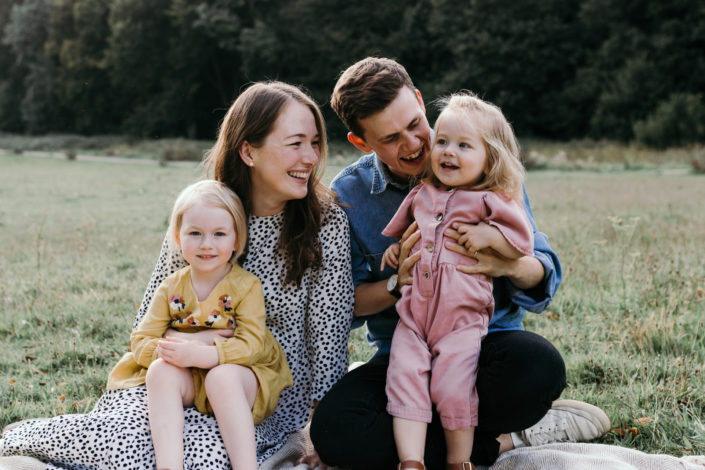 Family sitting on the grass. Happy memories. family lifestyle photoshoot in Basingstoke, Hampshire. Ewa Jones Photography