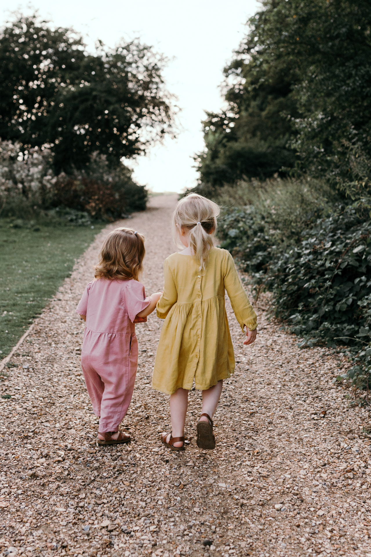 Sisters holding hands. Sunset family photoshoot in Basingstoke. Ewa Jones Photography