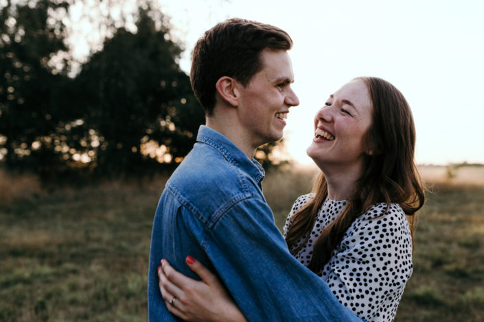 Couple is hugging during family sunset photoshoot. Hampshire. Ewa Jones Photography