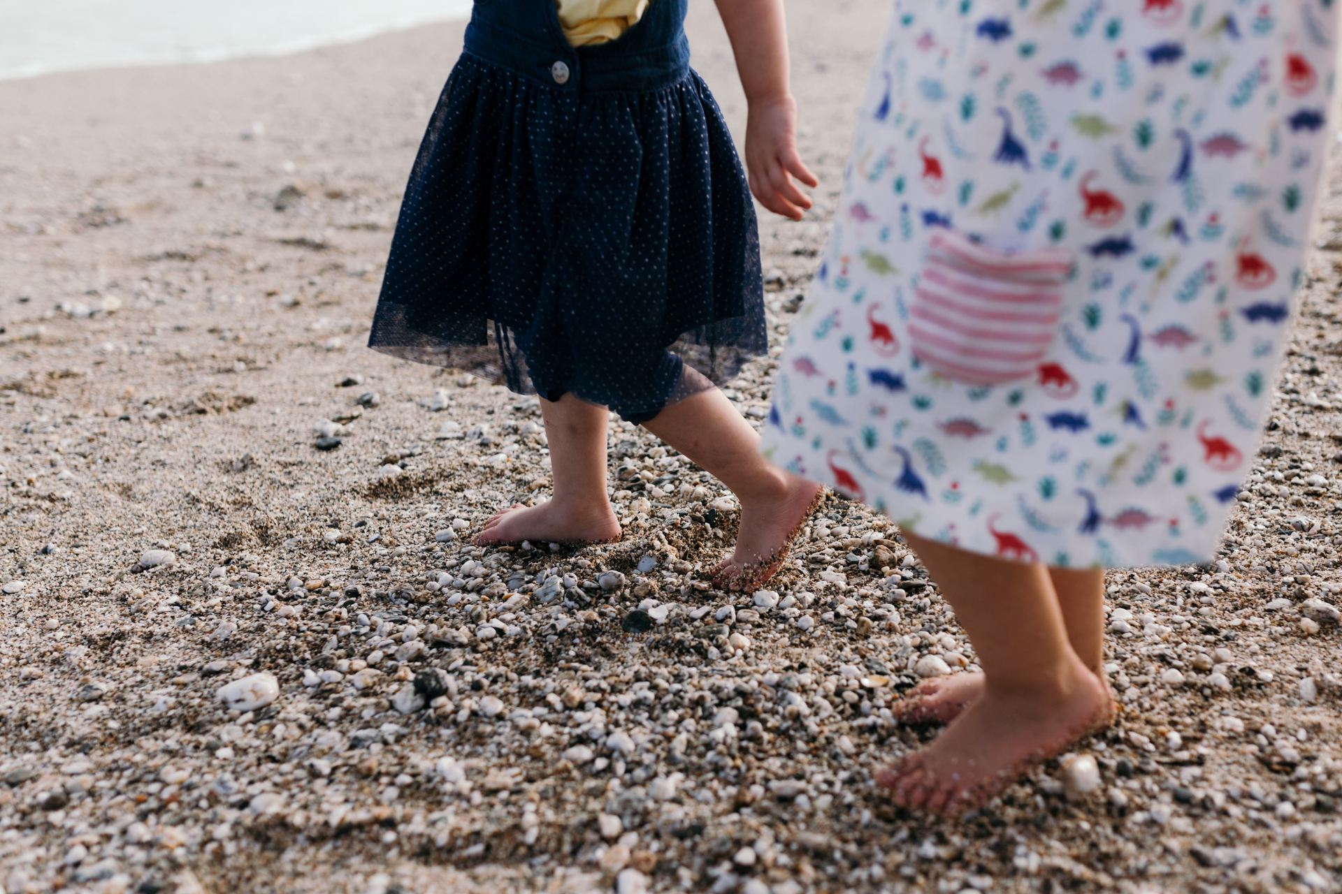 Girls feet walking on the beach by Ewa Jones Photography