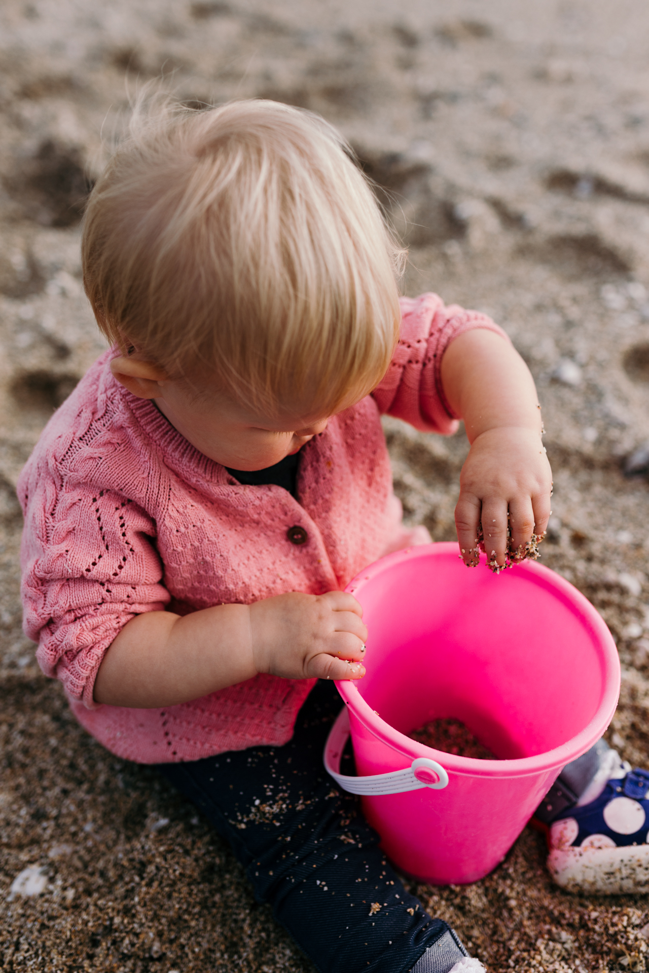 Girl playing with bucket and sand by Ewa Jones Photography | Hampshire Photography