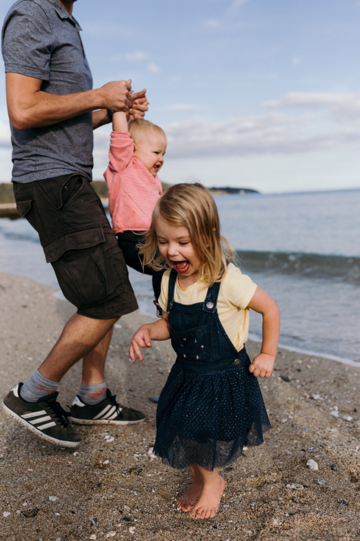 Girl running away from waves by Ewa Jones Photography | Hampshire lifestyle photography