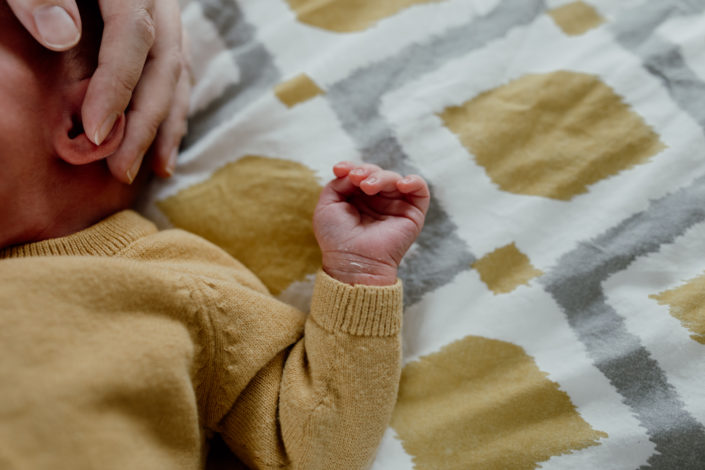 Baby left arm close up. Newborn details. Newborn laying on bed. close up of baby&#039;s hand. Newborn photoshoot in Hampshire. Ewa Jones Photography