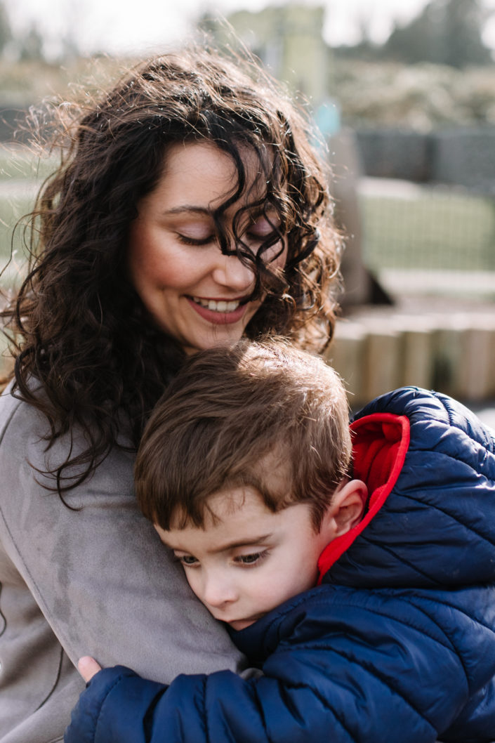 Mum is cuddling her son. They are in the park. Family photographer in hampshire. Ewa Jones Photography