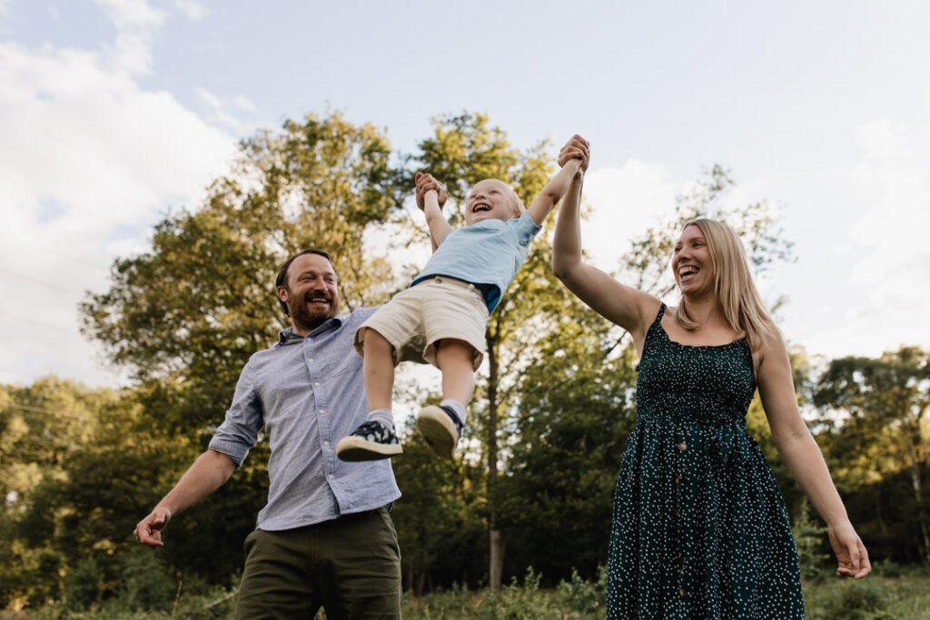 Mum and dad are lifting their boy in the air. Lovely family sunset photography. Family photo session with Emma Reed. Ewa Jones Photography
