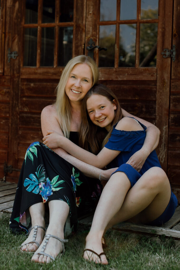 Mum and daughter are hugging each other and smiling. Lovely candid photograph of mother and daughter. Family photography in Basingstoke. Ewa Jones Photography
