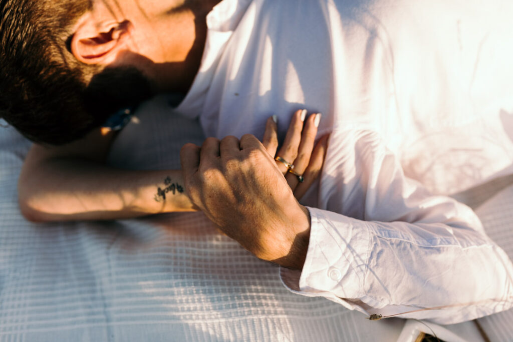 Close up of expecting mum holding hands with her husband. Maternity photo session in Hampshire. Ewa Jones Photography