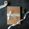 Close up of packaging for the family photography vouchers. Lovely brown box with cream ribbon on top. Newborn, maternity and family photography vouchers. Ewa Jones Photography