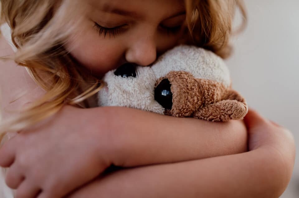 Little girl is cuddling her soft toy. Close up photograph. 7 tips on photographing kids at home. family photography in Hampshire. Ewa Jones Photography