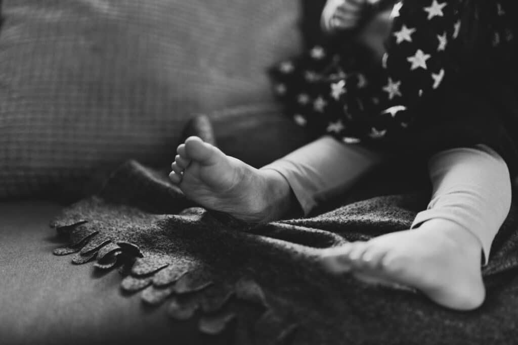 Close up details of little girl feet. Candid photography. Black and white photography. Ewa Jones Photography