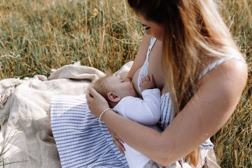 Mum is breasfeeding her little baby boy. family photographer in Hampshire. Ewa Jones Photography