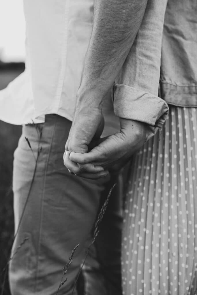 Black and white photograph of a couple holding hands. Maternity photo session in Hampshire. Ewa Jones Photography