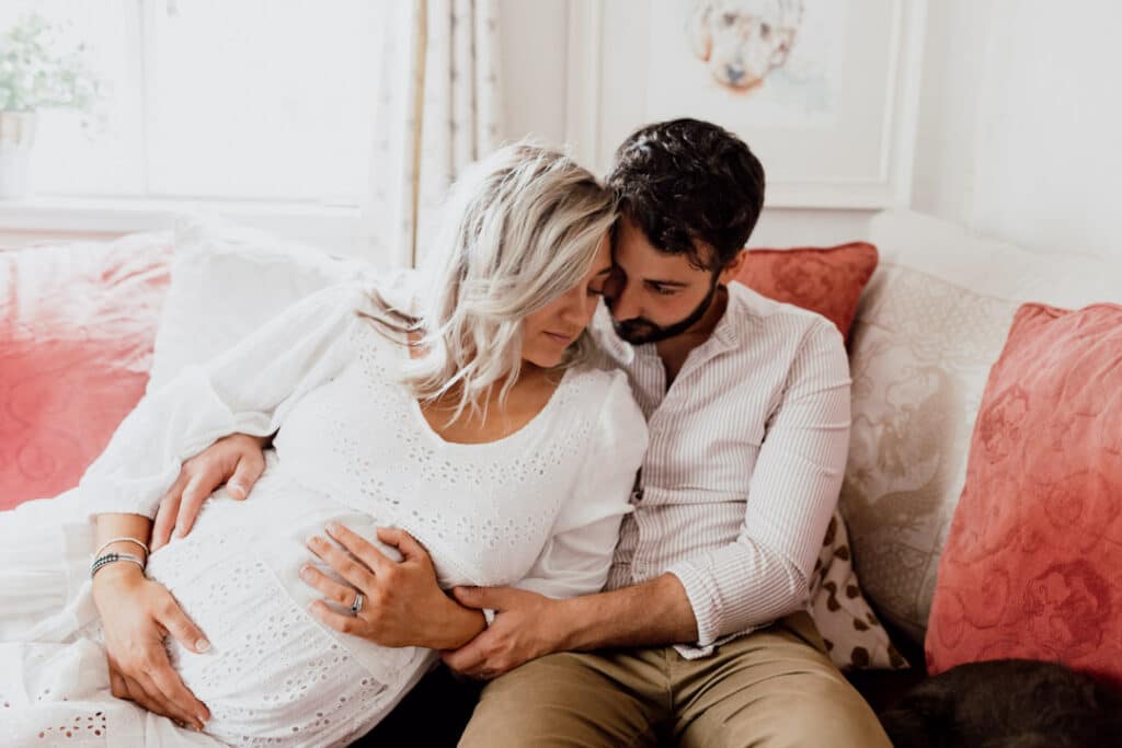 expecting parents are cuddling to each other. Maternity photography in Hampshire. Ewa Jones Photography.