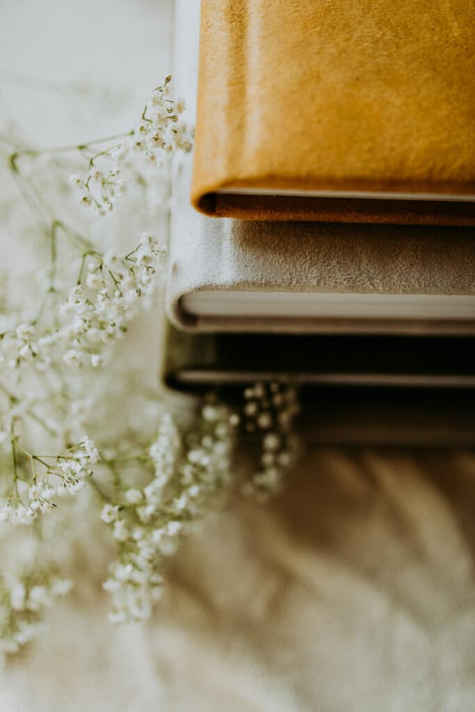 close up detail shot of 3 photo albums with various colours. Family photo albums. Ewa Jones Photography. Basingstoke photographer