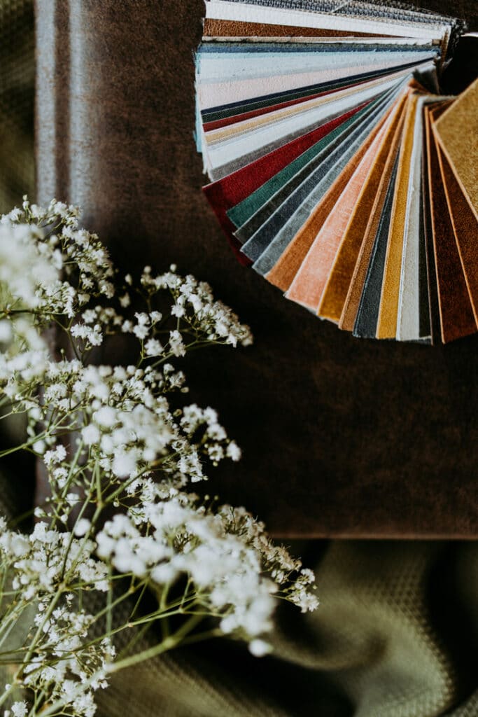 Photograph of album swatch samples in various colours on the ring. they lay on white photo album. Family photo albums. Family photographer in Basingstoke. Ewa Jones Photography