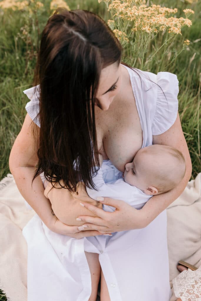 Mum is breastfeeding her little baby boy. Lovely candid photograph of mum and her baby. World breastfeeding week. Breastfeeding photo session in Basingstoke, Hampshire. Family photographer in Basingstoke, Ewa Jones Photography