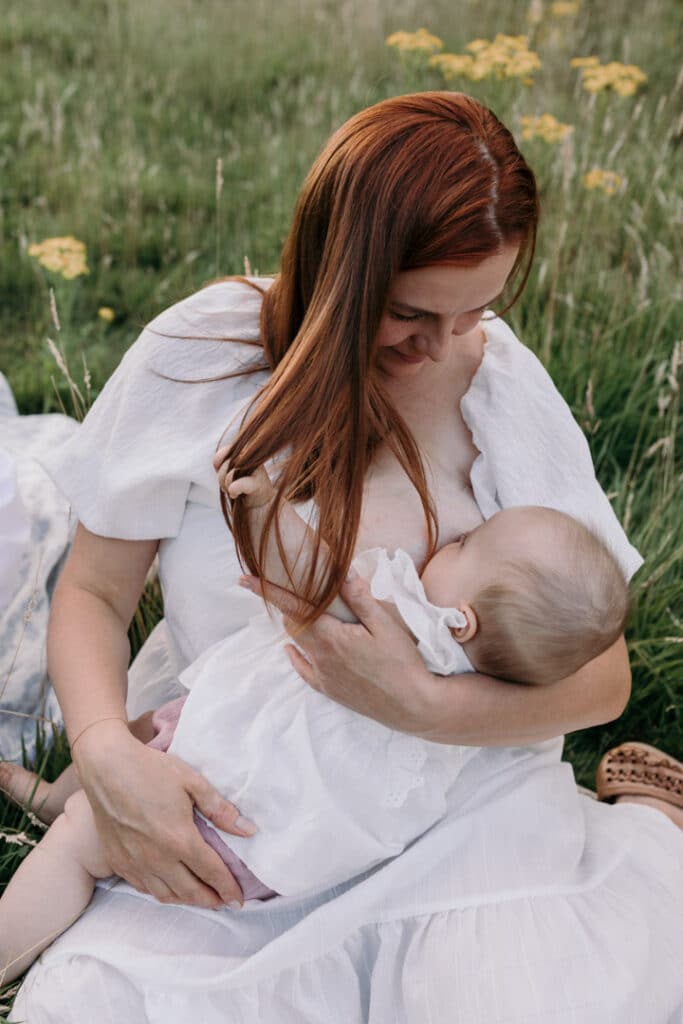 Mum is breastfeeding her little baby girl. Lovely candid photograph of mum and her baby. World breastfeeding week. Breastfeeding photo session in Basingstoke, Hampshire. Family photographer in Basingstoke, Ewa Jones Photography