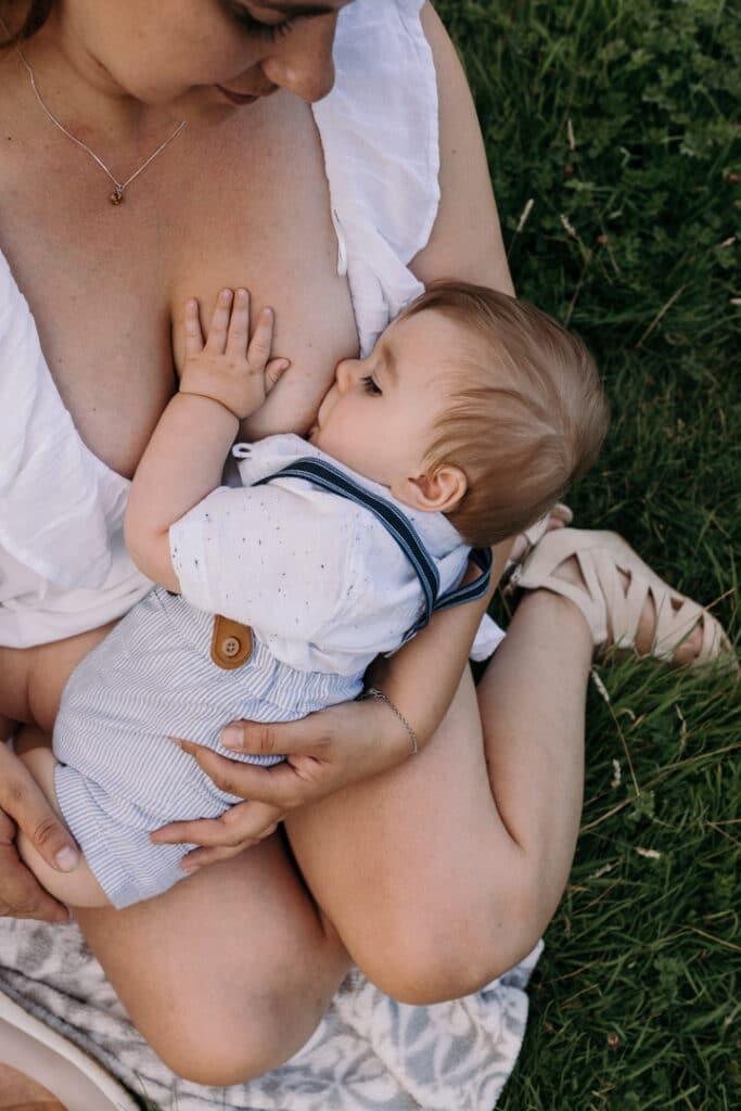 Mum is breastfeeding her little baby boy. Lovely candid photograph of mum and her baby. World breastfeeding week. Breastfeeding photo session in Basingstoke, Hampshire. Family photographer in Basingstoke, Ewa Jones Photography