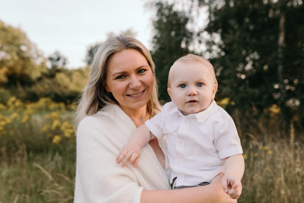 Little boy and his mum are looking at the camera and smiling. Lovely candid moment of mum and her little boy. Family photography in Basingstoke, Hampshire. Ewa Jones Photography