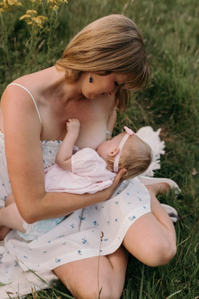 Mum is breastfeeding her girl. Lovely candid photograph of mum and her baby. World breastfeeding week. Breastfeeding photo session in Basingstoke, Hampshire. Family photographer in Basingstoke, Ewa Jones Photography