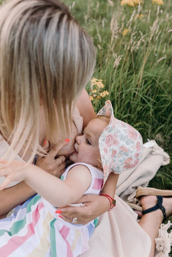 Mum is breastfeeding her girl. Lovely candid photograph of mum and her baby. World breastfeeding week. Breastfeeding photo session in Basingstoke, Hampshire. Family photographer in Basingstoke, Ewa Jones Photography