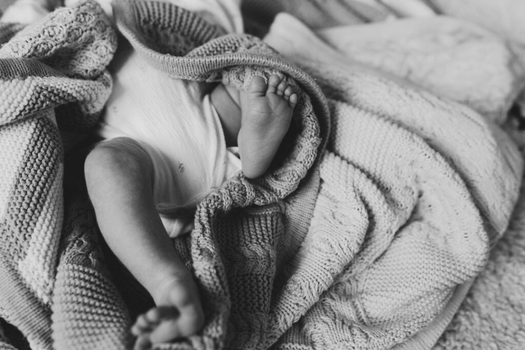 Black and white photograph of newborn baby feet. newborn photographer in Hampshire. Ewa Jones Photography