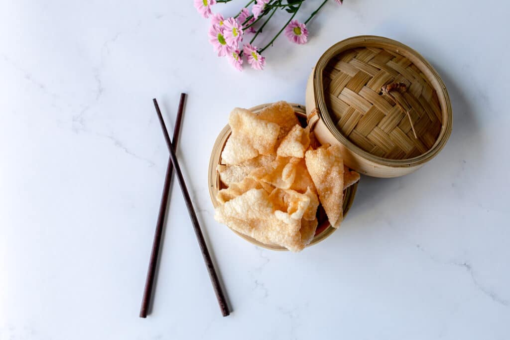 lovely home cooked Vietnamese crackers inside bamboo basket. Next there are chopsticks. food photography in Hampshire. Ewa Jones photography