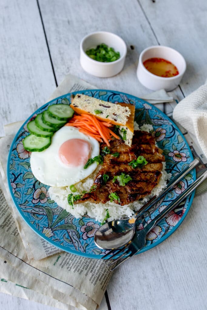 Vietnamese food on a blue plate. Lovely pork, rice, egg and vegetables. Food photography in Basingstoke, Hampshire. Ewa Jones Photography
