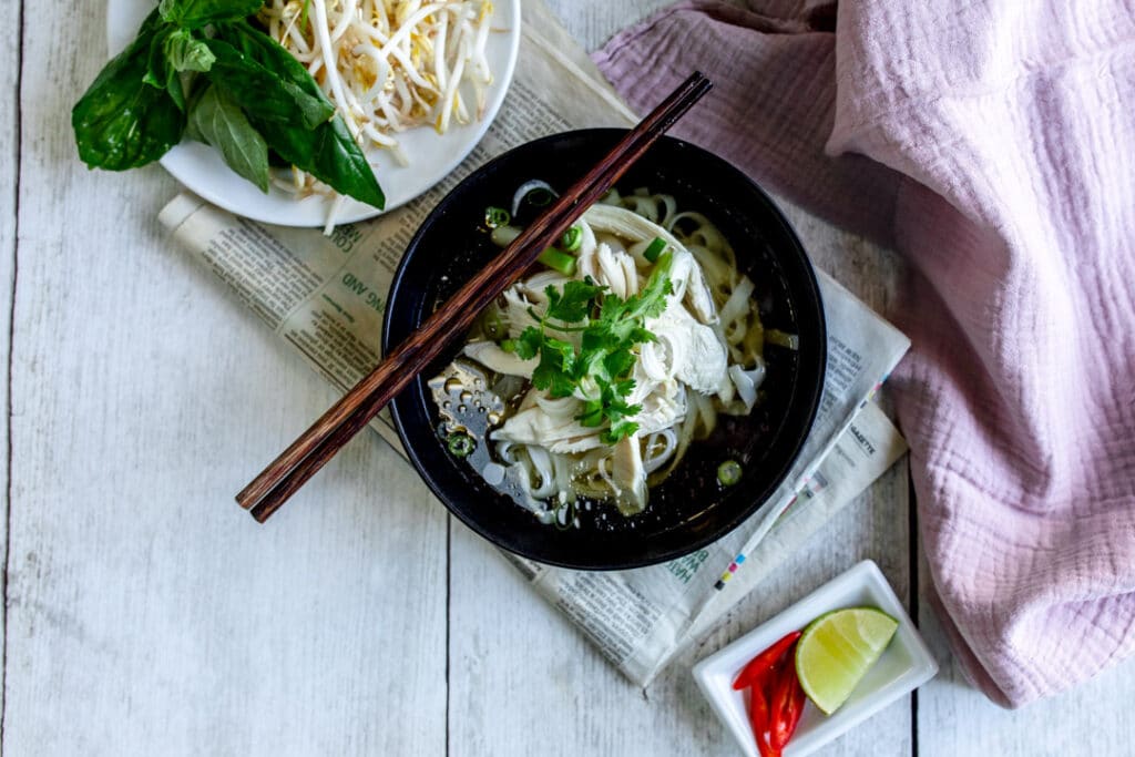 Lovely Vietnamese chicken noodle soup served with vegetables. Food photography with Banana Blossom. Ewa Jones Photography