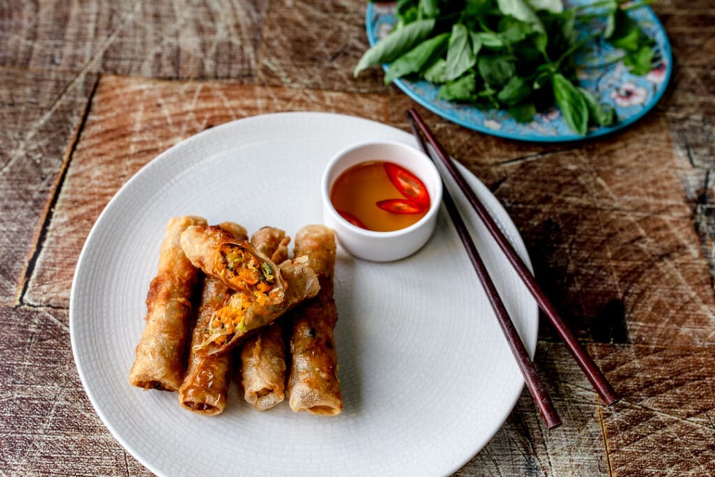 Authentic Vietnamese spring rolls on the white plate with sauce on the side. Food photography with Banana Blossom. Ewa Jones Photography