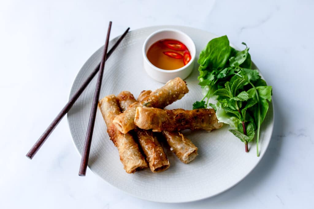 Authentic Vietnamese spring rolls on the white plate with sauce on the side. Food photography with Banana Blossom. Ewa Jones Photography