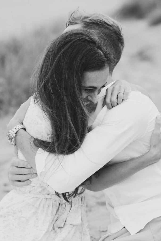 Couple is cuddling each other and sitting on the blanket. black and white photography on couple. Couples photographer in Hampshire. Ewa Jones Photography