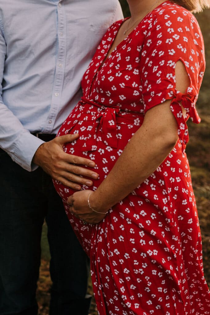 dad and expecting mum are both looking down at the baby. lovely black and white photograph of expecting parents. Maternity photographer in Hampshire. Ewa Jones Photography