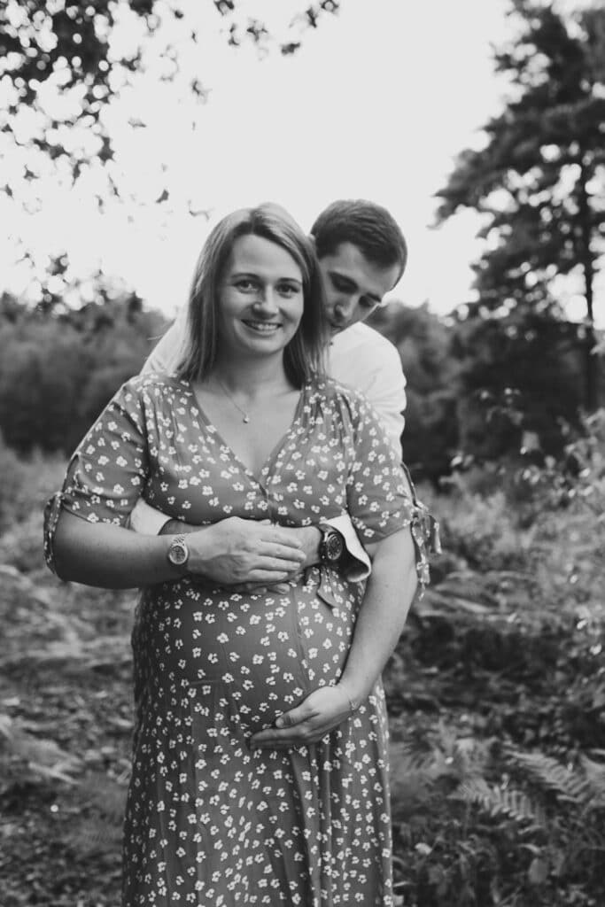 Black and white photograph of expecting mum and her husband. Her husband is looking at her lovingly. Lovely maternity photography in Hampshire. Ewa Jones Photography