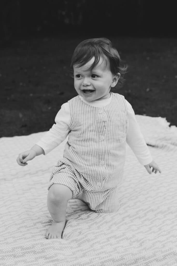 Little boy is smiling and looking away. black and white image. Family photo session in Hampshire. Ewa Jones Photography