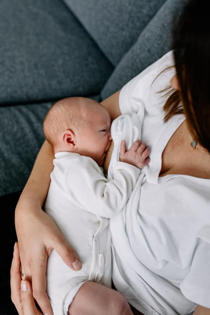 Mum is breastfeeding baby boy. Newborn photographer in Basingstoke, Hampshire. Ewa Jones Photography