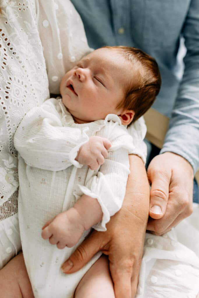 Newborn baby is sleeping on mummy's arms. Newborn photographer in Hampshire. Ewa Jones Photography