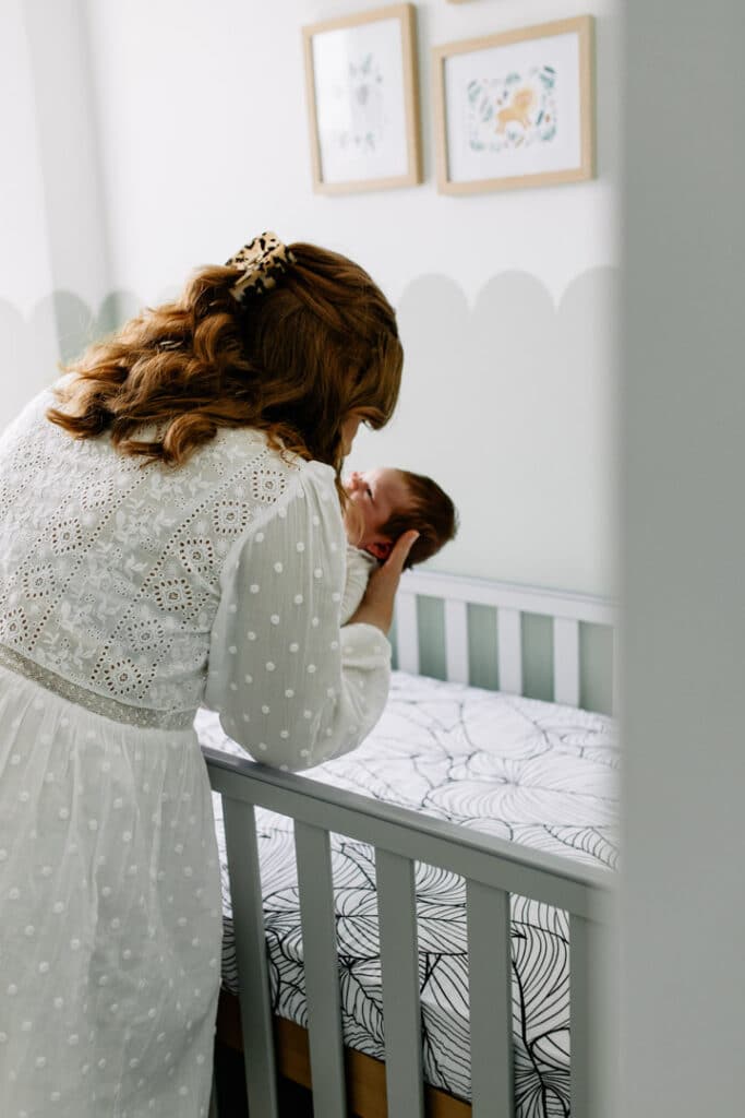 mum is putting down her newborn baby to sleep. Newborn photo shoot in Hampshire. Ewa Jones Photography