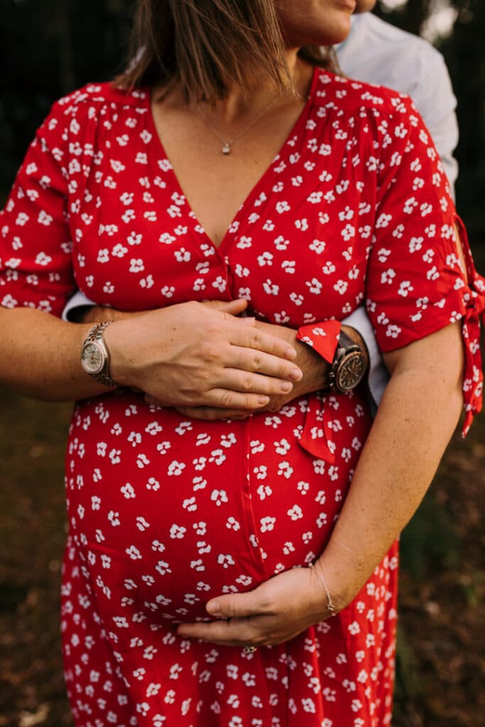 Expecting parents are holding baby bump in their arms. Lovely maternity photo session in Hampshire. Ewa Jones Photography